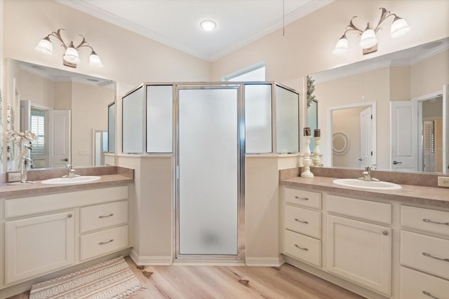 bathroom featuring crown molding, wood-type flooring, walk in shower, and vanity