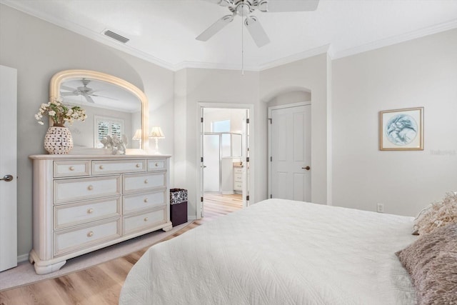 bedroom featuring crown molding, ensuite bath, ceiling fan, and light wood-type flooring