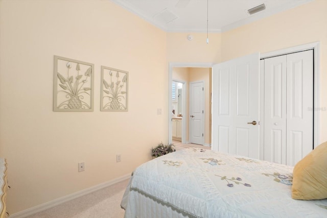 carpeted bedroom with ornamental molding and a closet