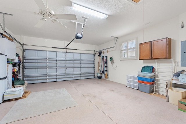 garage with ceiling fan, a garage door opener, and electric panel