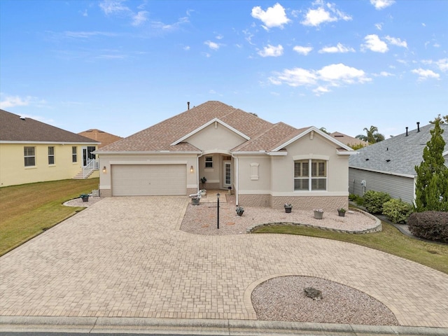 ranch-style home with a garage and a front lawn