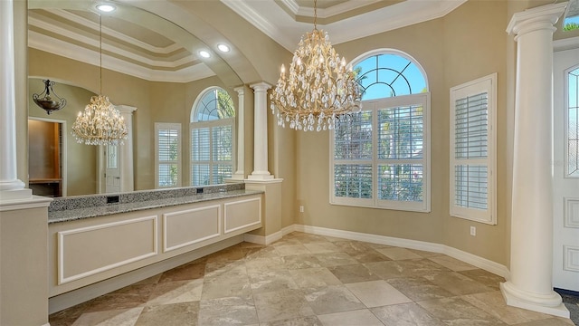 bathroom with a notable chandelier, ornamental molding, decorative columns, and a raised ceiling