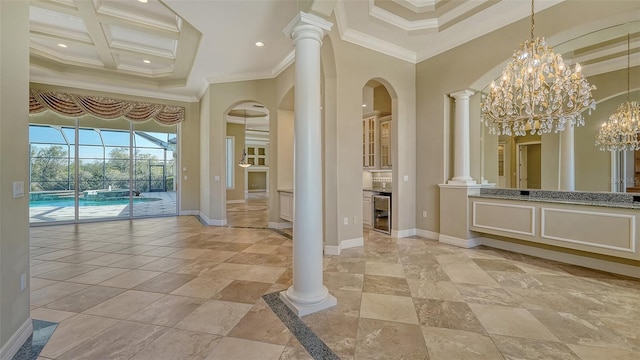 interior space featuring a towering ceiling, decorative columns, coffered ceiling, wine cooler, and ornamental molding