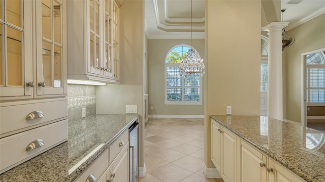 kitchen with light stone countertops, plenty of natural light, and ornamental molding