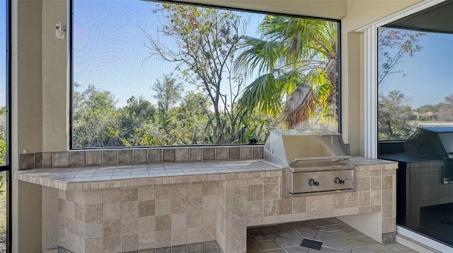 view of patio with exterior kitchen and grilling area