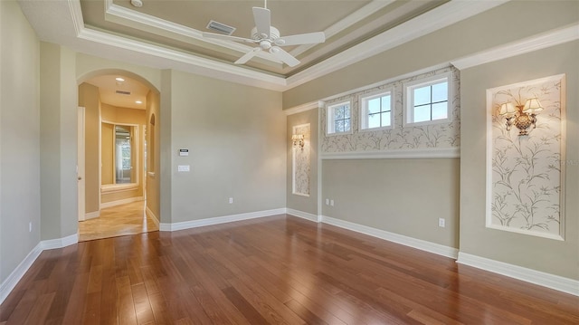 unfurnished room featuring crown molding, hardwood / wood-style flooring, a raised ceiling, and ceiling fan