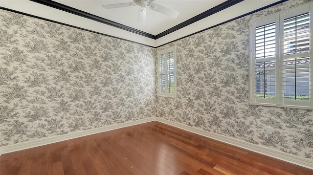 spare room with hardwood / wood-style flooring, ornamental molding, a healthy amount of sunlight, and ceiling fan