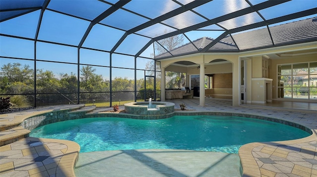 view of pool with an in ground hot tub, a patio, ceiling fan, and glass enclosure