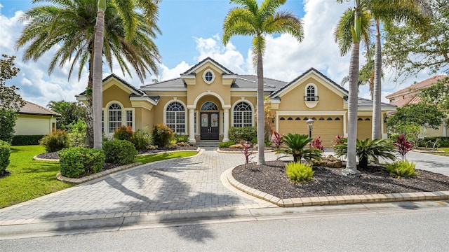 13616 Legends Walk Ter, Lakewood Ranch, FL 34202 - view of front facade with stucco siding, curved driveway, and an attached garage