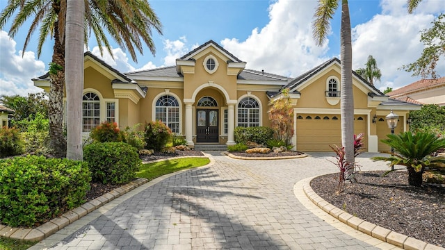 13616 Legends Walk Ter, Lakewood Ranch, FL 34202 - mediterranean / spanish-style home with stucco siding and curved driveway