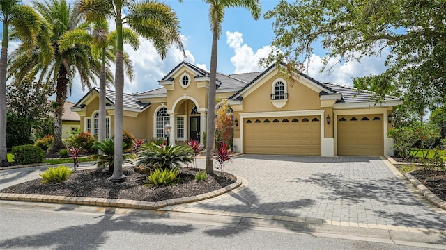 13616 Legends Walk Ter, Lakewood Ranch, FL 34202 - view of front of house with stucco siding, decorative driveway, and a garage