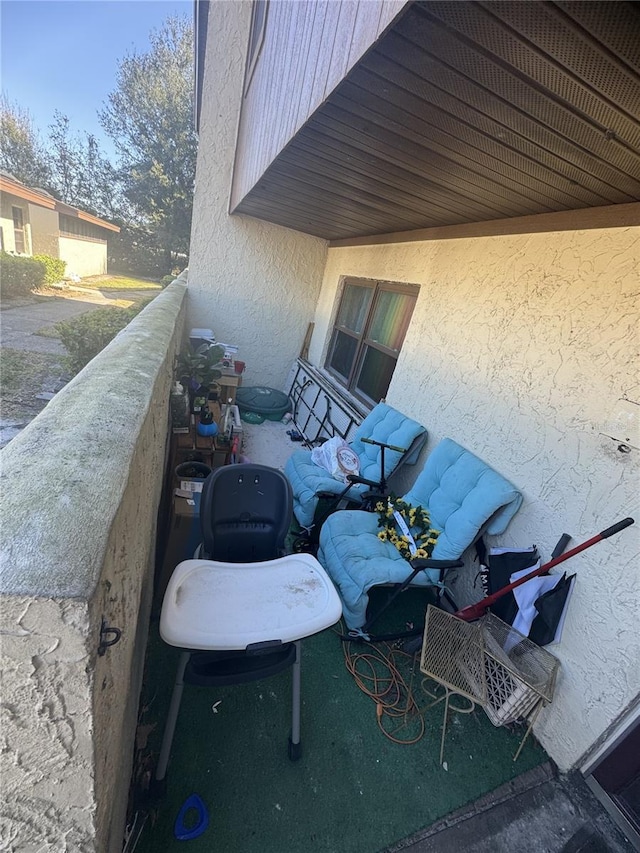 view of patio featuring a balcony