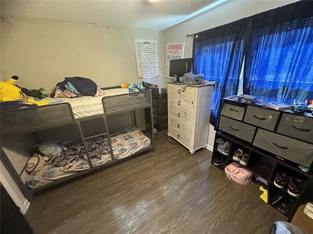 bedroom with dark wood-type flooring