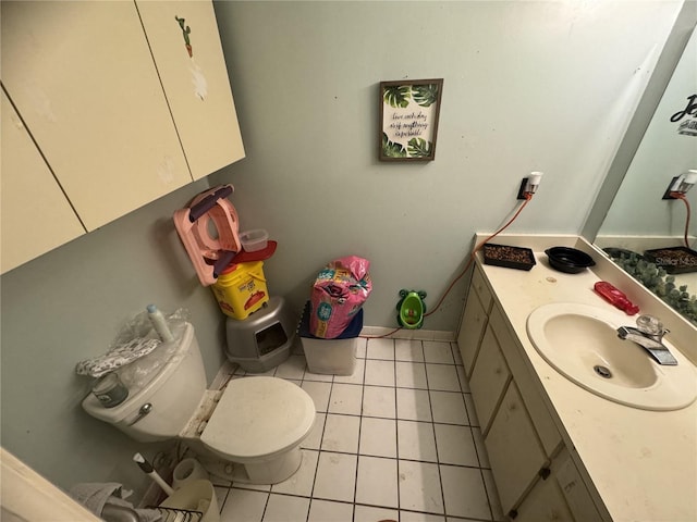 bathroom with vanity, toilet, and tile patterned flooring