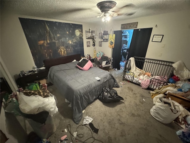 carpeted bedroom with a textured ceiling and ceiling fan