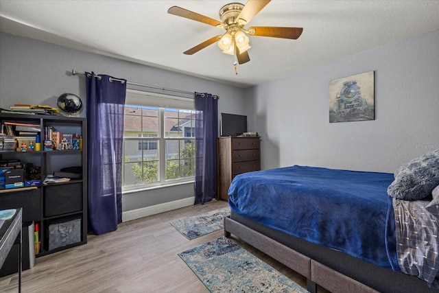 bedroom featuring ceiling fan and light hardwood / wood-style flooring