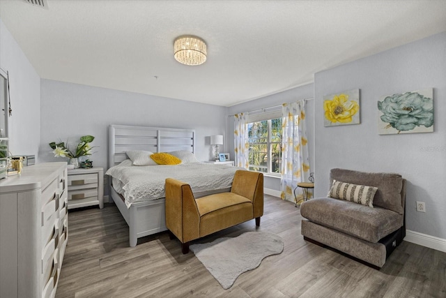 bedroom with hardwood / wood-style floors