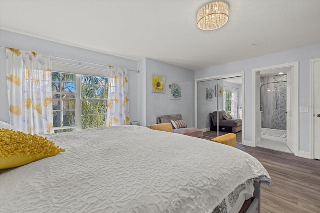 bedroom with hardwood / wood-style flooring, connected bathroom, and a closet