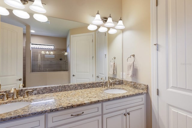 bathroom with vanity and tiled shower