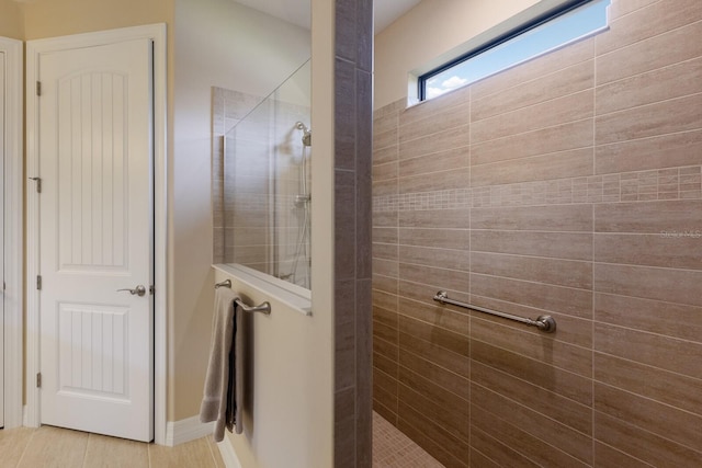 bathroom with tiled shower