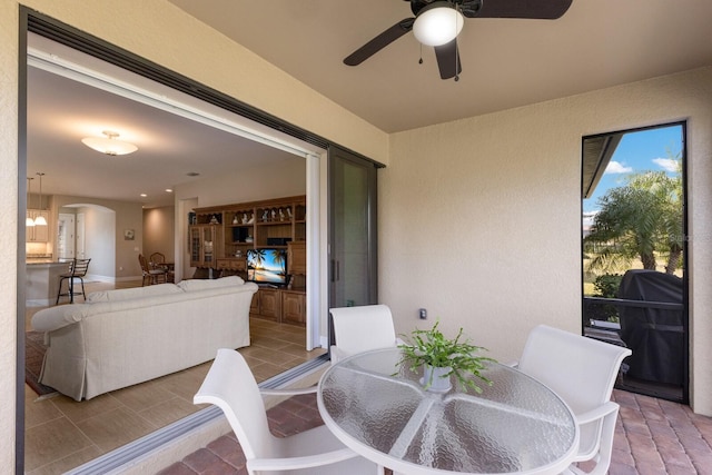 view of patio / terrace featuring ceiling fan, an outdoor living space, and area for grilling