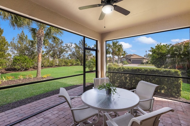 unfurnished sunroom with ceiling fan