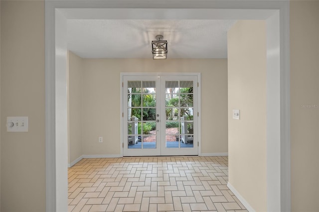 doorway to outside featuring a textured ceiling, french doors, and baseboards