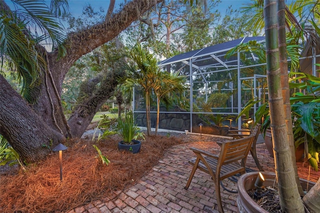 view of patio featuring glass enclosure