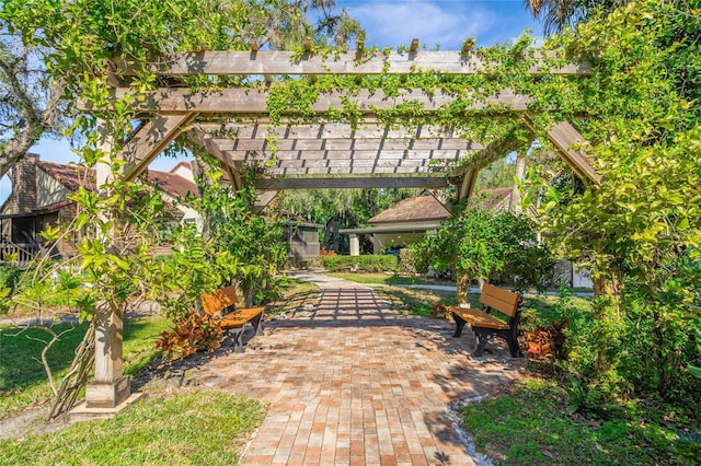 view of property's community featuring a pergola and a patio