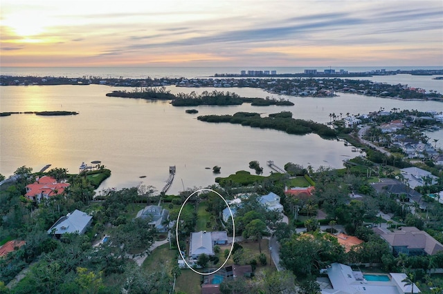 aerial view at dusk with a water view