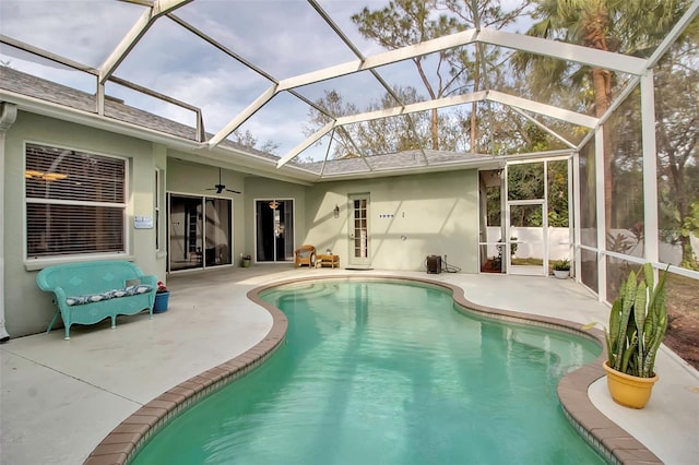 view of pool featuring ceiling fan, a lanai, and a patio area