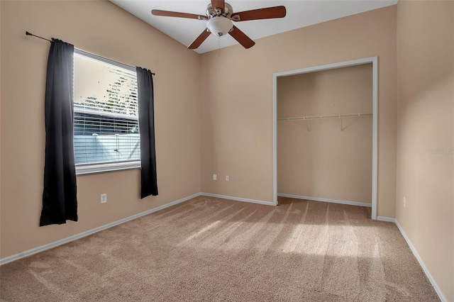 unfurnished bedroom with carpet flooring, ceiling fan, and a closet