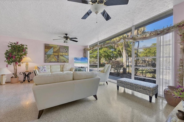 living room featuring ceiling fan, a healthy amount of sunlight, and a textured ceiling