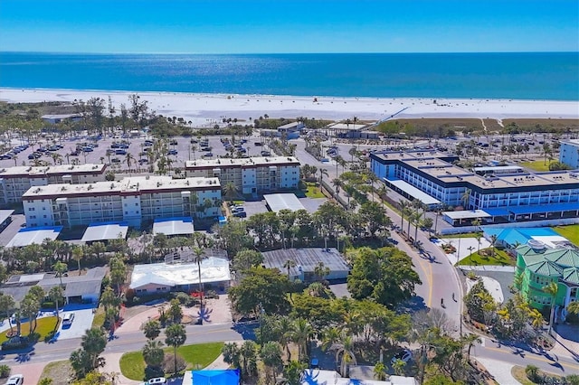 birds eye view of property featuring a water view and a beach view