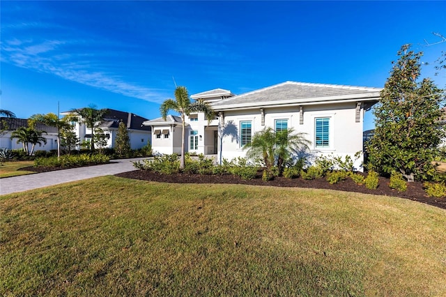 ranch-style home featuring a front yard