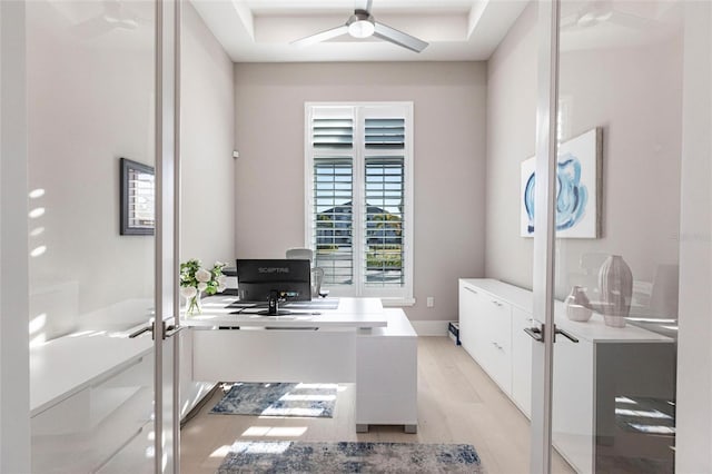 office with light hardwood / wood-style flooring, ceiling fan, and french doors