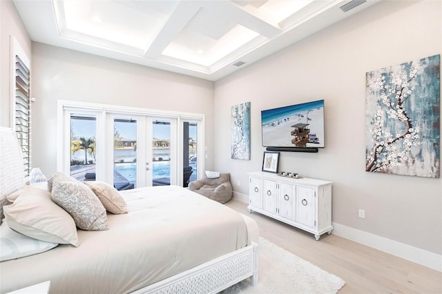 bedroom featuring coffered ceiling, access to outside, light hardwood / wood-style floors, beam ceiling, and french doors