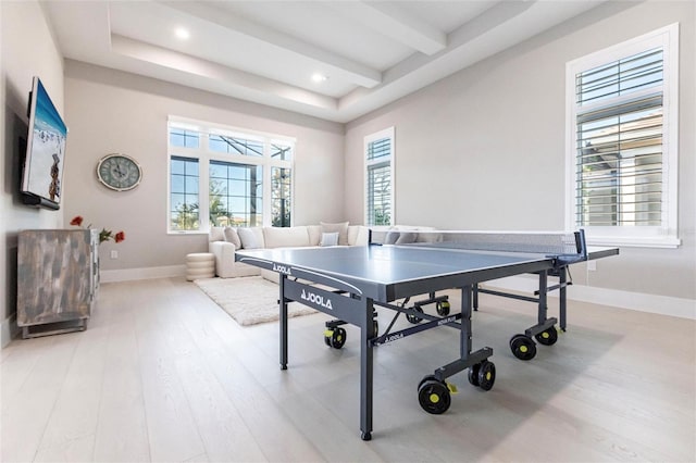 game room with beam ceiling and light hardwood / wood-style floors