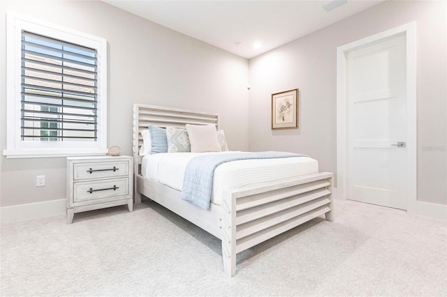 bedroom with light colored carpet