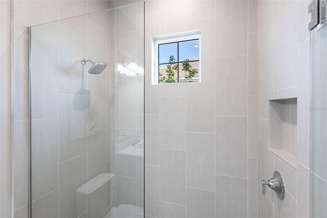 bathroom with tiled shower