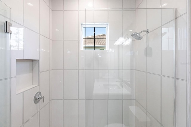 bathroom with a shower with door