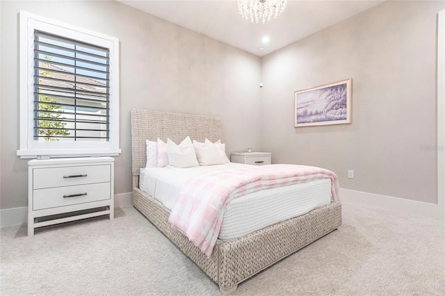 carpeted bedroom featuring a chandelier