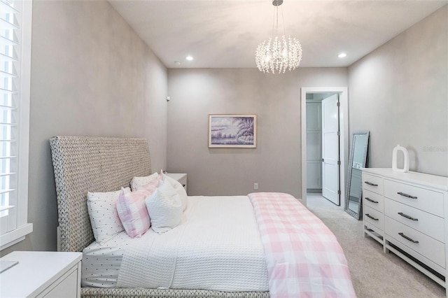 bedroom with light colored carpet and a notable chandelier