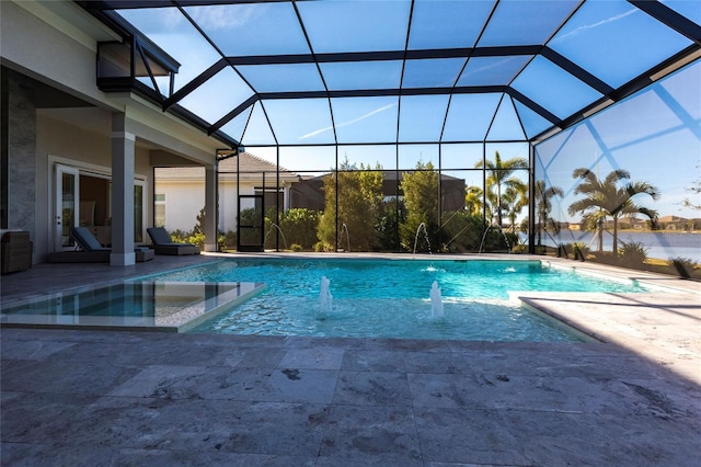 view of pool with a patio, a lanai, and pool water feature