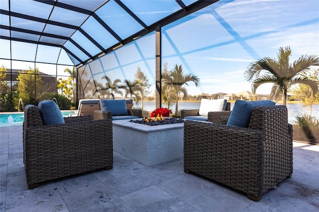 view of patio with pool water feature, a fire pit, and glass enclosure