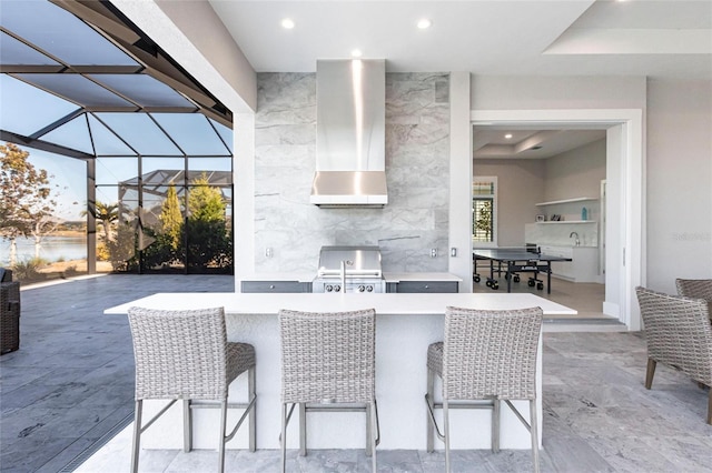 view of patio / terrace with exterior kitchen, a wet bar, grilling area, and glass enclosure