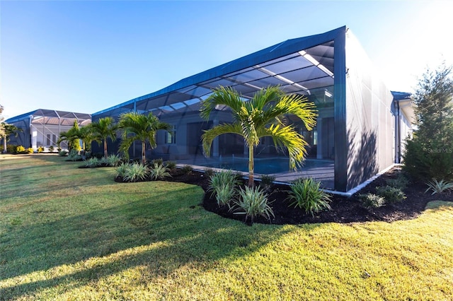 view of home's exterior with a yard and a lanai