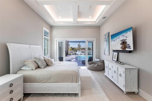 bedroom featuring coffered ceiling, a high ceiling, light hardwood / wood-style flooring, and access to outside