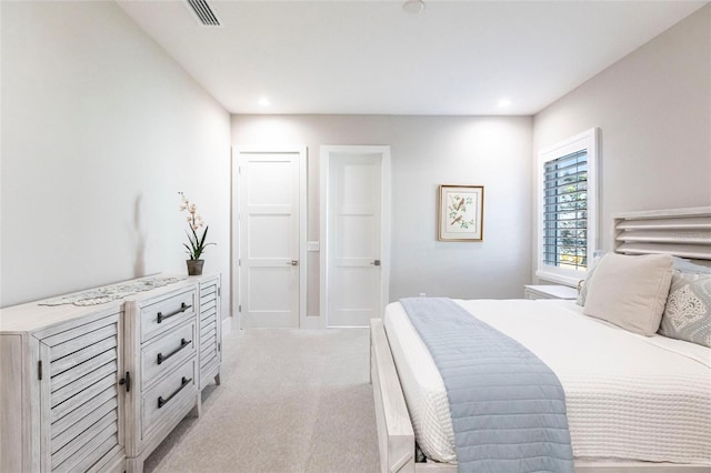 bedroom featuring light carpet