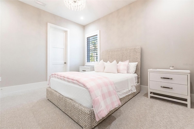 carpeted bedroom featuring a notable chandelier